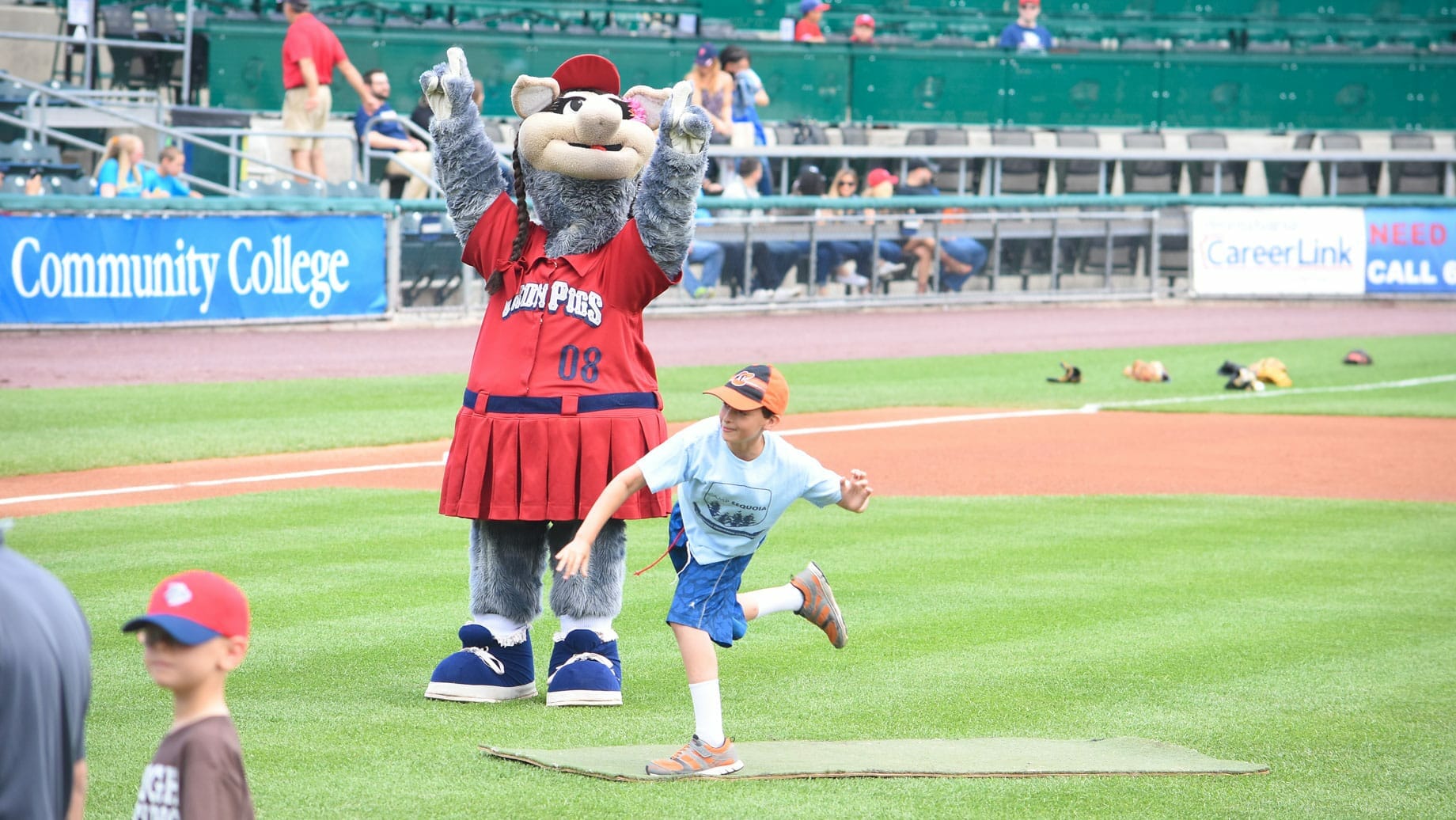 Camper throwing first pitch at a baseball game