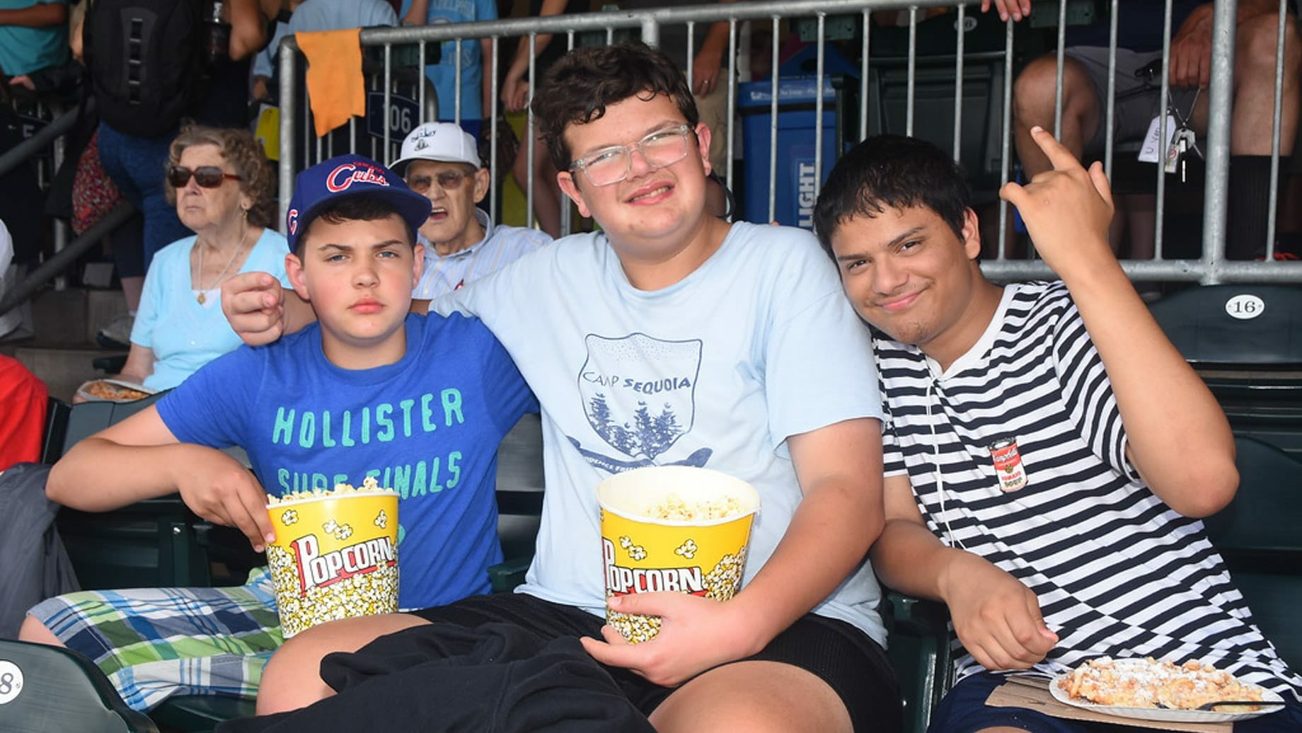 LITs at a sports game eating popcorn