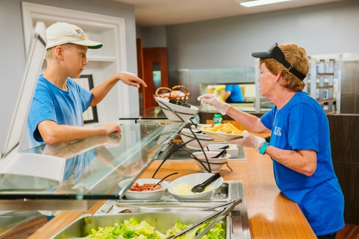 Lunch staff serving food to campers