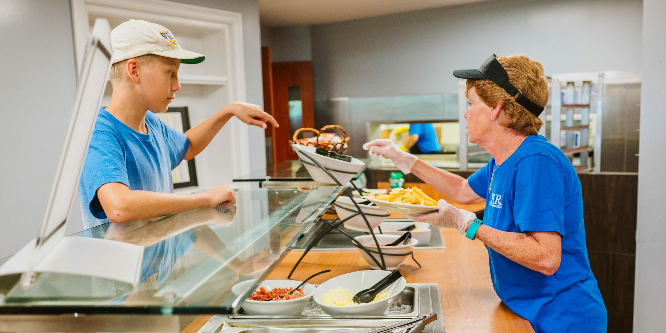 Lunch staff serving food to campers
