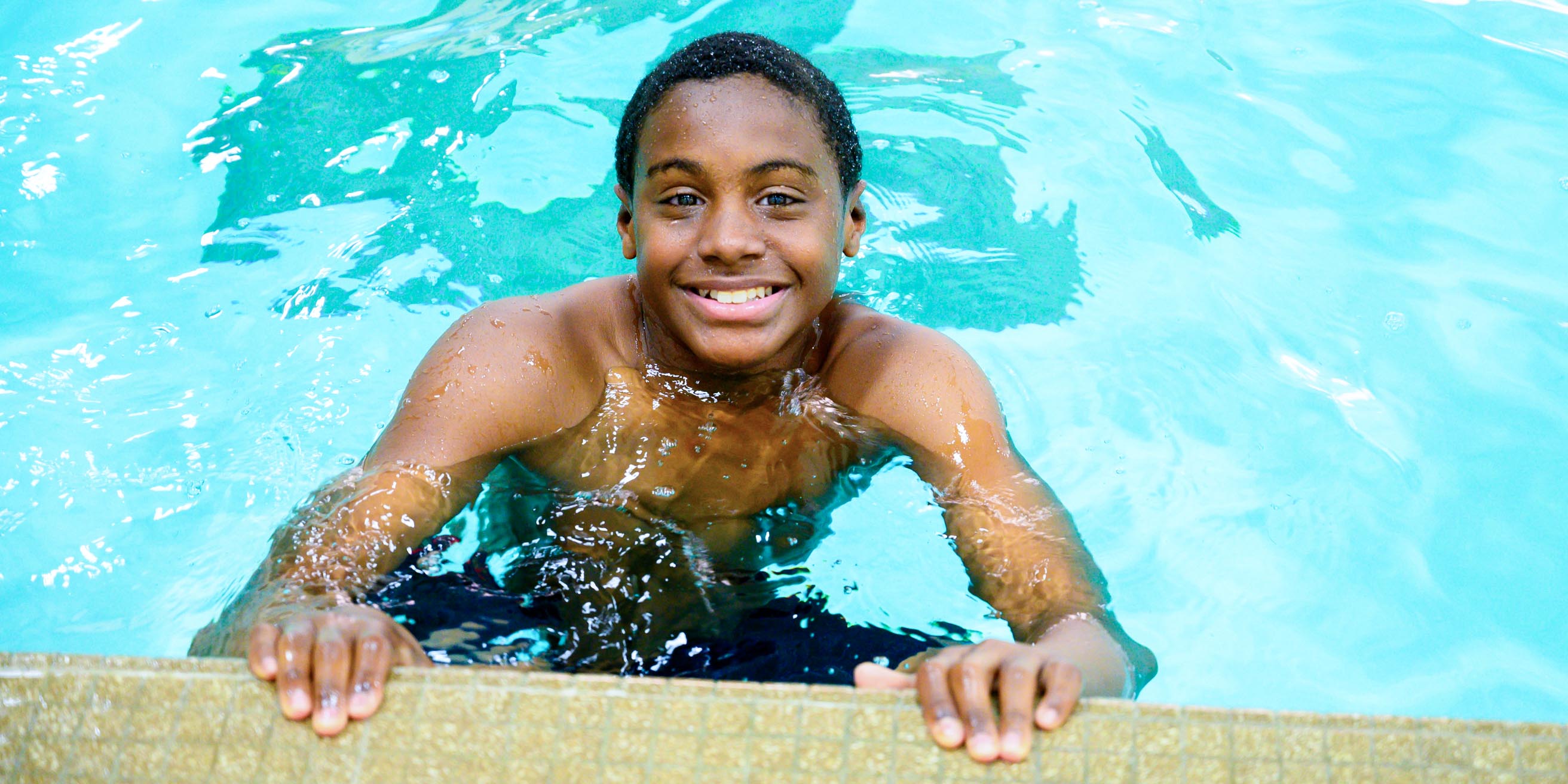 Boy swimming in pool