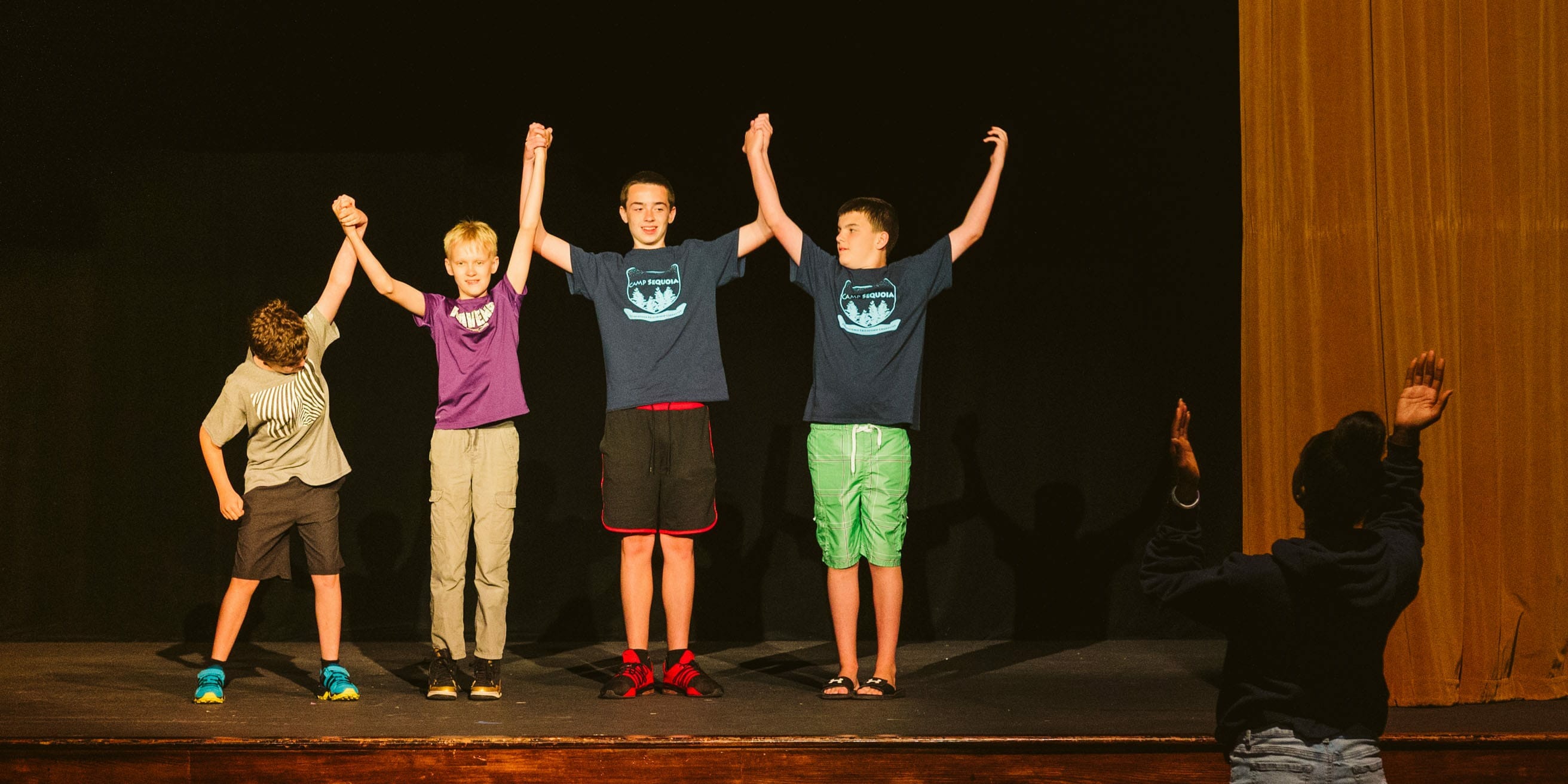 Kids performing improv in the theater