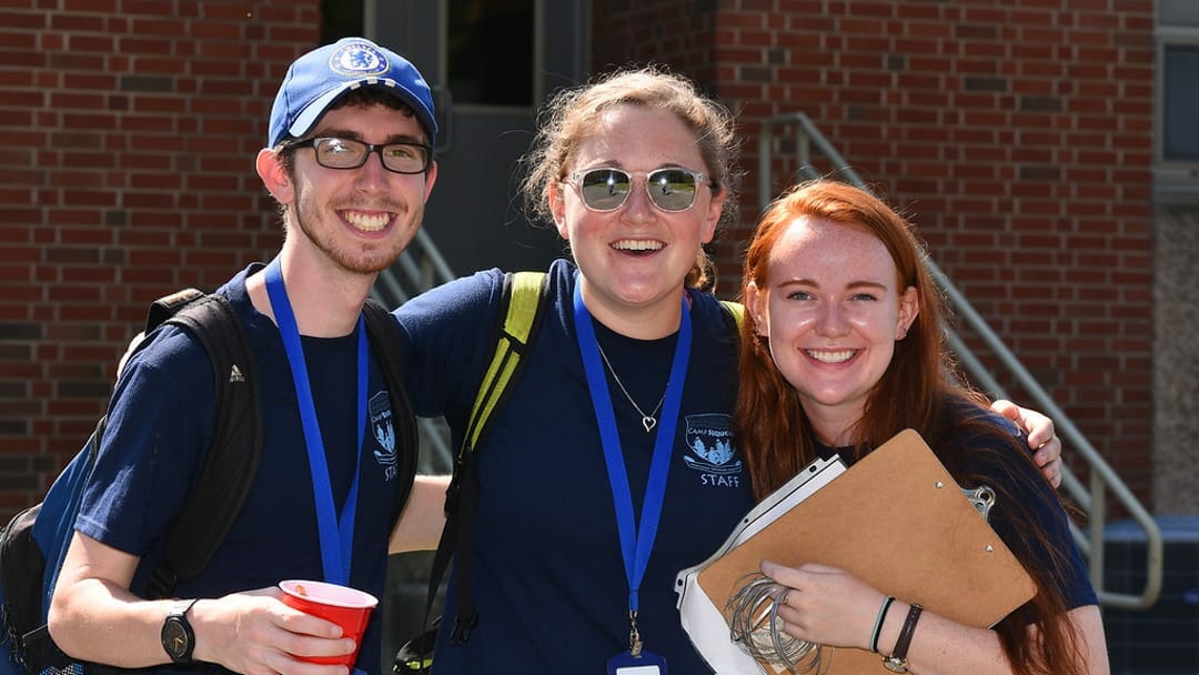 Three staff members smiling