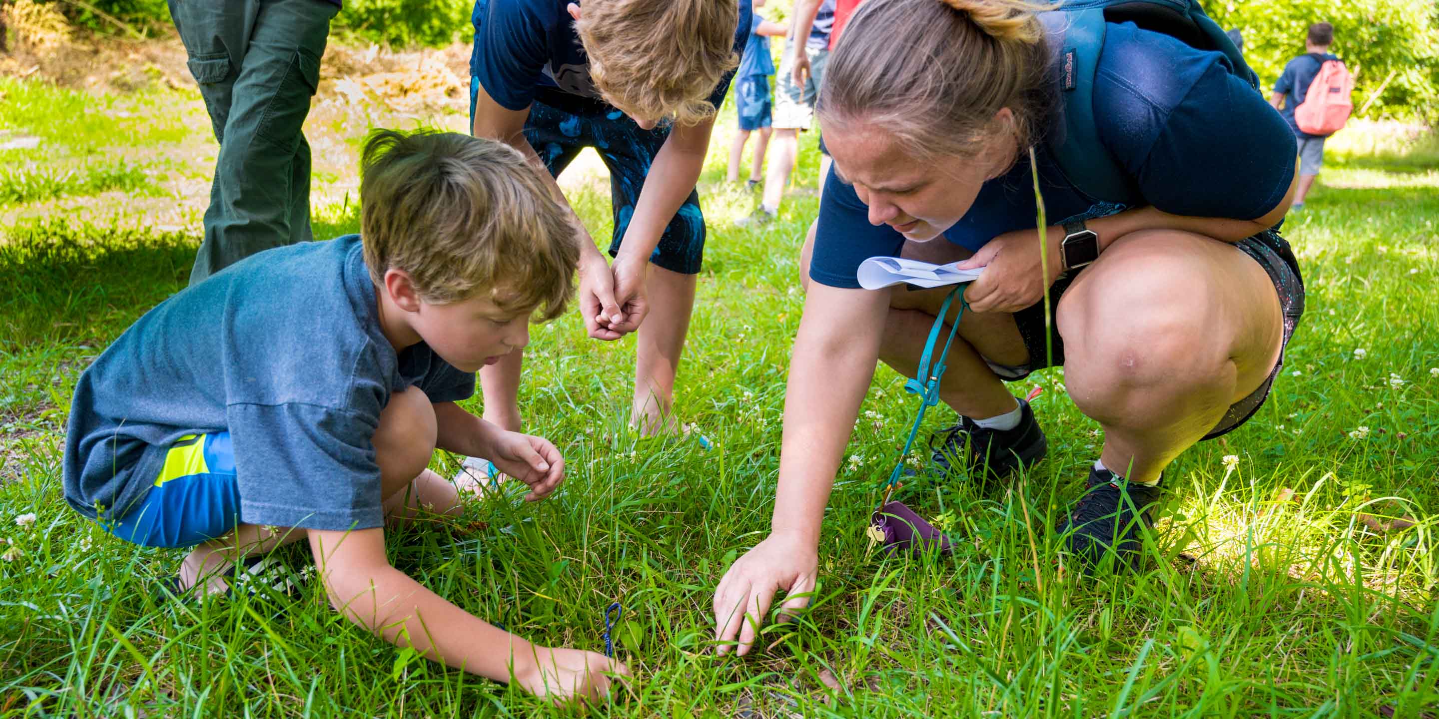 Staff and campers examining nature