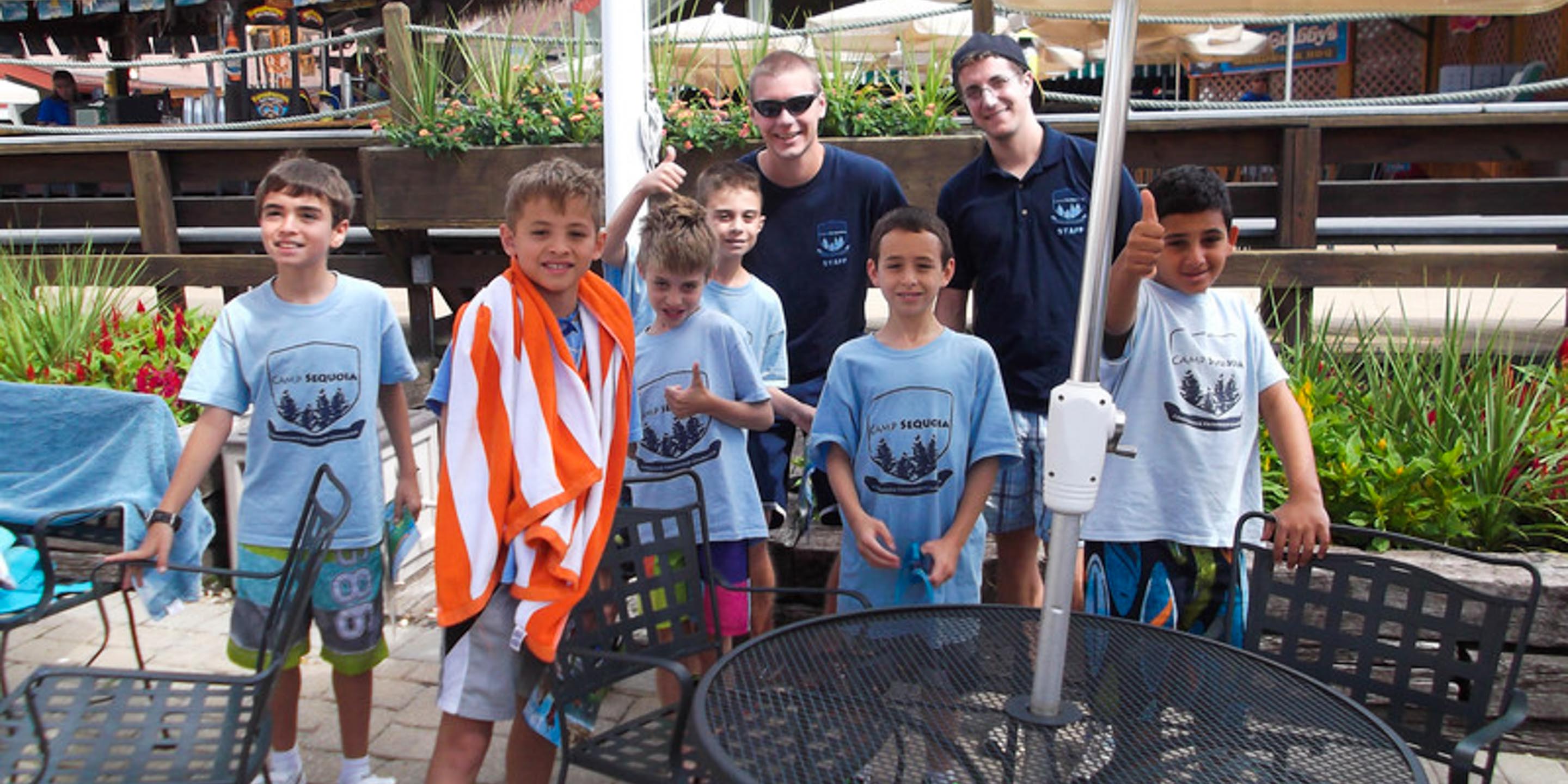 Group of boys on a spring break trip in bathing suits and towels